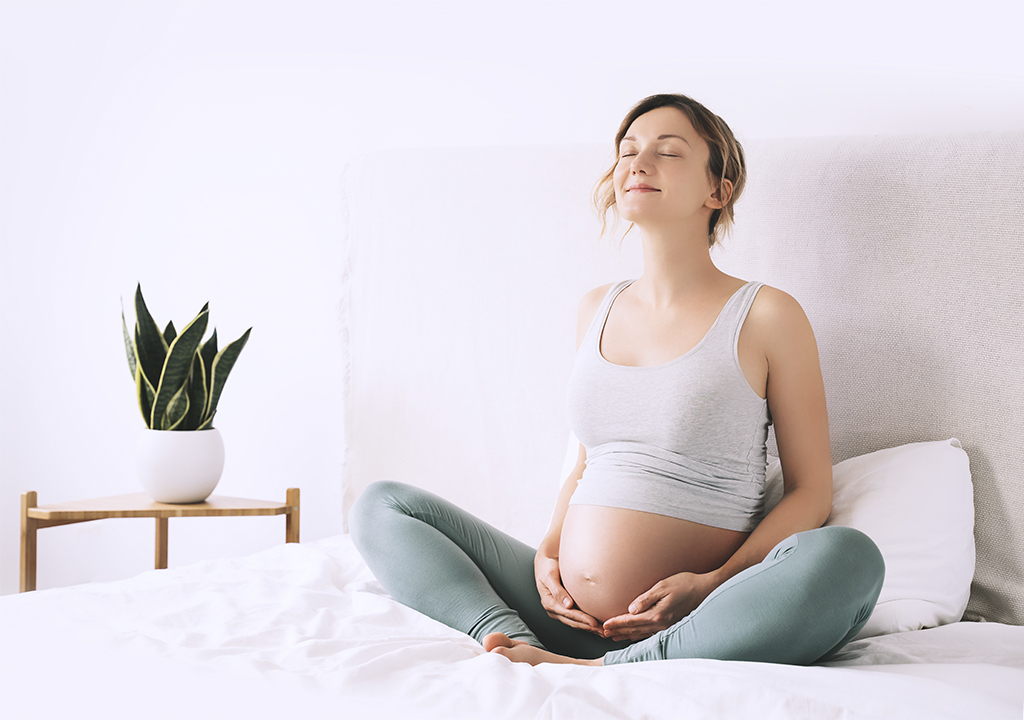 Kobieta w ciąży wykonująca proste ćwiczenia oddechowe